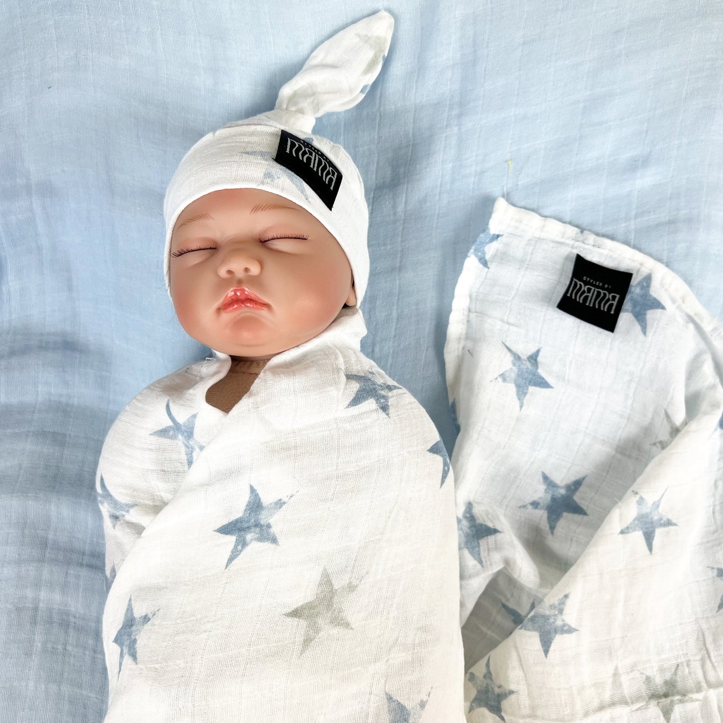 Baby blue stars print muslin organic cotton swaddles styled by mommy and me Arabia