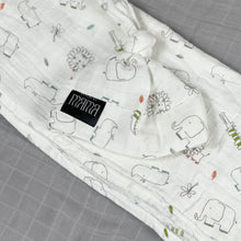 Load image into Gallery viewer, Wild world Muslin organic cotton swaddles styled by mommy and me arabia