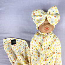 Load image into Gallery viewer, Yellow stars muslin organic cotton swaddles styled by mommy and me arabia