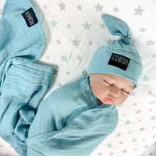 Load image into Gallery viewer, Solid sapphire blue print muslin organic cotton swaddles styled by mommy and me arabia