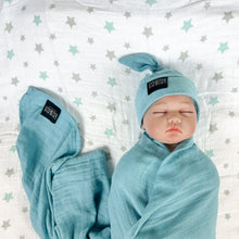 Load image into Gallery viewer, Solid sapphire blue print muslin organic cotton swaddles styled by mommy and me arabia