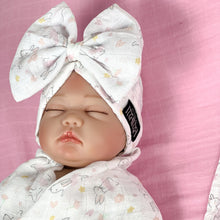Load image into Gallery viewer, Happy bunny pink printed Muslin organic cotton swaddles styled by mommy and me arabia