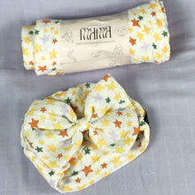 Load image into Gallery viewer, Yellow stars muslin organic cotton swaddles styled by mommy and me arabia