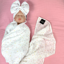 Load image into Gallery viewer, Happy bunny pink printed Muslin organic cotton swaddles styled by mommy and me arabia