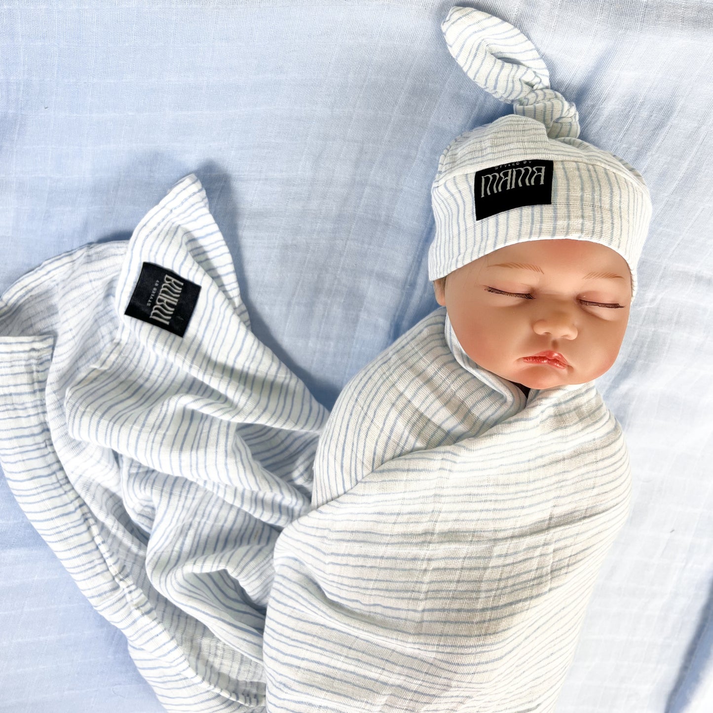 Baby blue stripes print muslin organic cotton swaddles styled by mommy and me arabia