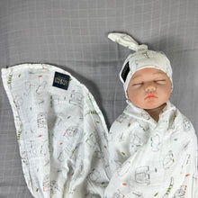 Load image into Gallery viewer, Wild world Muslin organic cotton swaddles styled by mommy and me arabia
