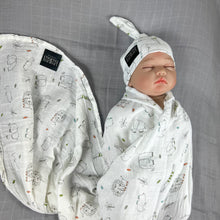 Load image into Gallery viewer, Wild world Muslin organic cotton swaddles styled by mommy and me arabia
