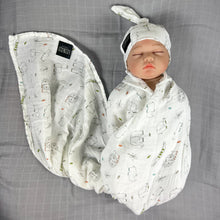 Load image into Gallery viewer, Wild world Muslin organic cotton swaddles styled by mommy and me arabia
