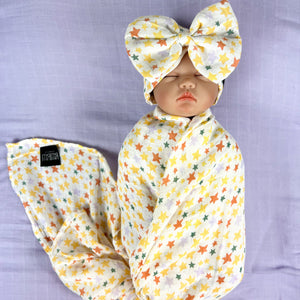 Yellow stars muslin organic cotton swaddles styled by mommy and me arabia