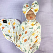 Load image into Gallery viewer, Sunshine blossom muslin organic cotton swaddles styled by mommy and me arabia
