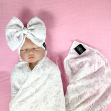 Load image into Gallery viewer, Happy bunny pink printed Muslin organic cotton swaddles styled by mommy and me arabia
