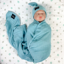 Load image into Gallery viewer, Solid sapphire blue print muslin organic cotton swaddles styled by mommy and me arabia
