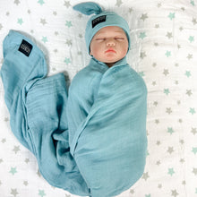 Load image into Gallery viewer, Solid sapphire blue print muslin organic cotton swaddles styled by mommy and me arabia
