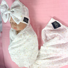 Load image into Gallery viewer, Happy bunny pink printed Muslin organic cotton swaddles styled by mommy and me arabia
