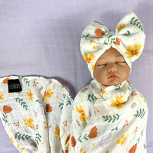 Load image into Gallery viewer, Sunshine blossom muslin organic cotton swaddles styled by mommy and me arabia
