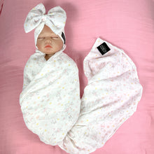 Load image into Gallery viewer, Happy bunny pink printed Muslin organic cotton swaddles styled by mommy and me arabia
