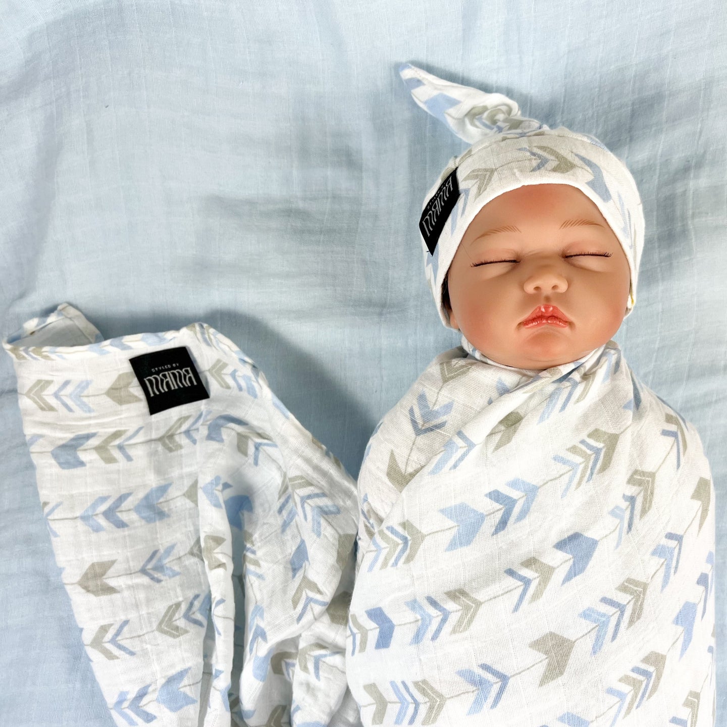 Baby blue arrow print muslin organic cotton swaddles styled by mommy and me Arabia