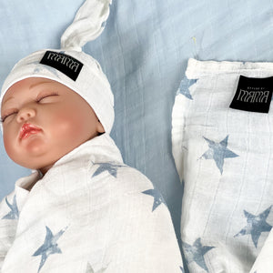 Baby blue stars print muslin organic cotton swaddles styled by mommy and me Arabia