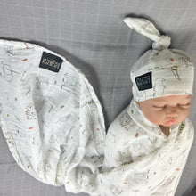 Load image into Gallery viewer, Wild world Muslin organic cotton swaddles styled by mommy and me arabia
