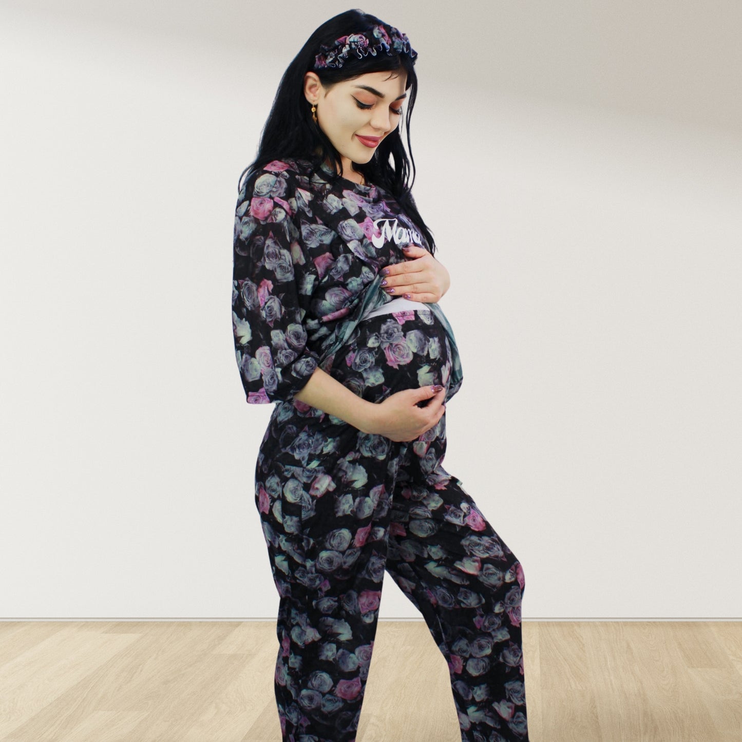 maternity nursing pajama set with baby romper breathable cottoN,mom and baby and wearing a matching pajama set with a floral pattern. The set includes a button-down top with drop shoulders and side buttons for breastfeeding, and matching romper for the baby.made in uae